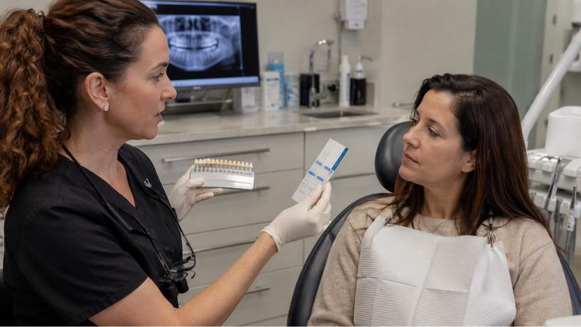 Dentist explaining whitening strip safety during a consultation.